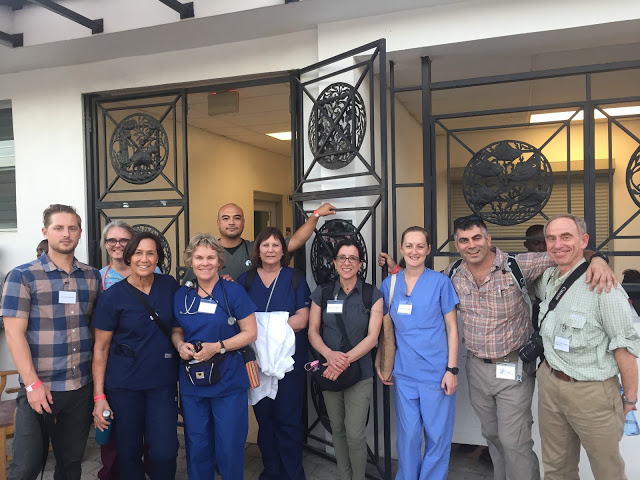 SB Team Haiti at the entrance gates of the hospital, from L to R: Dr. Connor Johnson, Patti Wicklund, Kaina Gomard, Maggie Cote, Mario Guillen, Diane Barkas, Dr. Lisa Ferrigno, Dr. Kacie Brumley, Dr. Jason Prystowsky, Dr. Jeffrey Fried. Photo courtesy DWW-SBSM