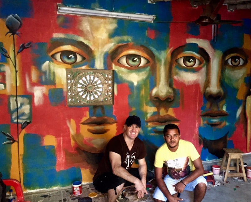 Gus Harper with Akash, tuk tuk driver, in front of the club in Santiniketan, India. 