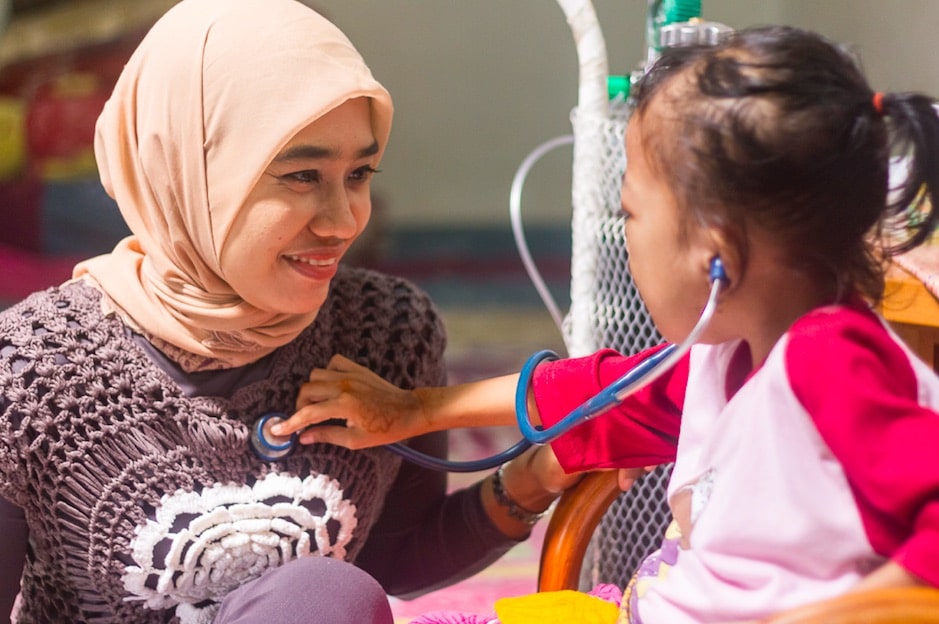 Rachel House nurse playing with patient. Photo by Jason Tan.